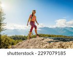 Hiking people. Woman hiker on mountain hike trail enjoying view wearing backpack and hiking clothing in beautiful blue sky nature landscape. Squamish hike, British Columbia, Canada