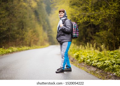 Hiking. Senior 60 Years Old Woman Hiker Smiling Walk In Autumn Forest. Active Retirement Concept