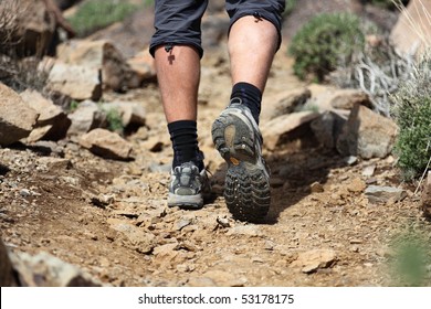 hiking shoes in action on a mountain desert trail path. Close-up of male hikers shoes. Photo is from Tenerife. - Powered by Shutterstock