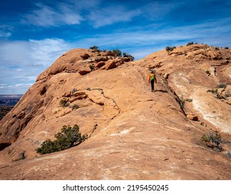 Hiking Up Slickrock At Upheaval Dome In Canyonlands National Park In Utah