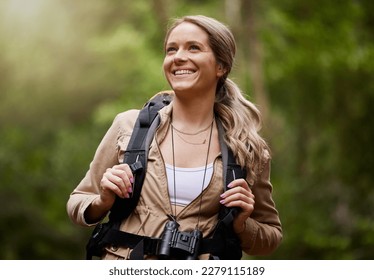 Hiking, smile and woods with a woman outdoor, walking in nature or the wilderness for adventure. Freedom, location and forest with an attractive young female hiker taking a walk in a natural park