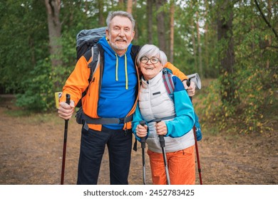 Hiking tourism adventure. Senior couple man woman enjoying outdoor recreation hiking in forest. Happy old people backpackers hikers enjoy walking hike trekking tourism active vacation beauty of nature - Powered by Shutterstock