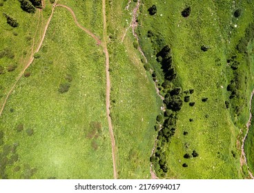 Hiking Trail Along The Riverbed. Tourists Climb The Trail To The Mountains. Aerial Photography In The Mountains View Down.