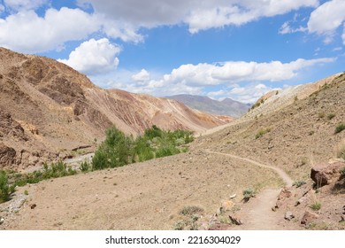 A Hiking Trail In The Altai Mountains On A Sunny Day Against A Background Of Blue Sky And Clouds. Concept - Tourist Places.
