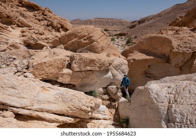 Hiking Trail In Dry Wadi Tahmason, Judaean Desert, Southern Israel. Female Hiker Posing Above A Narrow Stone Gate.