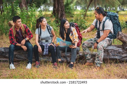 Hiking Trail In The Forest With Friends. Walk Through Countryside And Read The Map. Hikers Looking At Map. Teamwork Outdoor Activity. Trekking. Camping And Wild Life Concept.                    