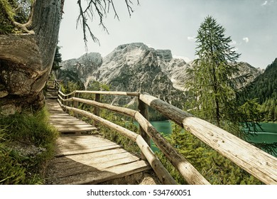 Hiking trail at Lake Braies in the Dolomites with the Seekofel mountain in the background, Sudtirol,Italy. (HDR image with black gold filter)
