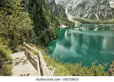 Hiking trail at Lake Braies in the Dolomites with the Seekofel mountain in Italy (HDR image with black gold filter)