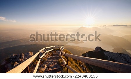 Hiking trail to peak of Mount Pilatus. Alpine landscape at beautiful sunrise. Morning mist in valley near Lucerne in Switzerland. Foto stock © 