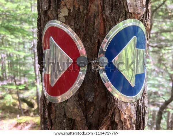 Hiking trail signs send\
mixed signals