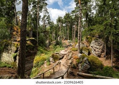 Hiking trail through forest and sandstone rocks in Prachov Rocks, Bohemian Paradise, Czech Republic