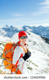 Hiking and walking woman, success and freedom in mountains. Fitness and healthy lifestyle outdoors in winter nature. Female mountaineer, climber on mountain ridge in Tatras, Poland.