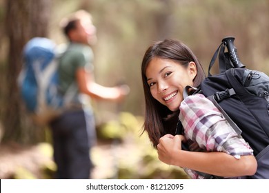 Hiking. Woman Hiker Smiling In Forest With Male Hiker In The Background. Mixed-race Asian Caucasian Female Model Happy. From Aguamansa, Tenerife, Spain