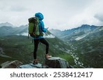 Hiking woman taking photo with smart phone  on high altitude mountain top