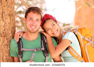 Hiking Young Couple Portrait Of Happy Hikers In Bryce Canyon Walking Smiling Happy Together. Multiracial Couple, Young Asian Woman And Caucasian Man In Love, Bryce Canyon National Park Landscape, Utah