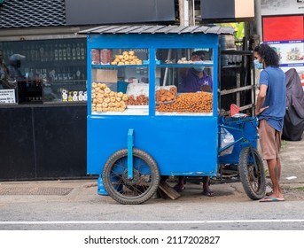 Hikkaduwa  Sri Lanka - 26.01.2022: 
 Asian Food Trader. Food Vendor Sri Lanka With Blue Cart