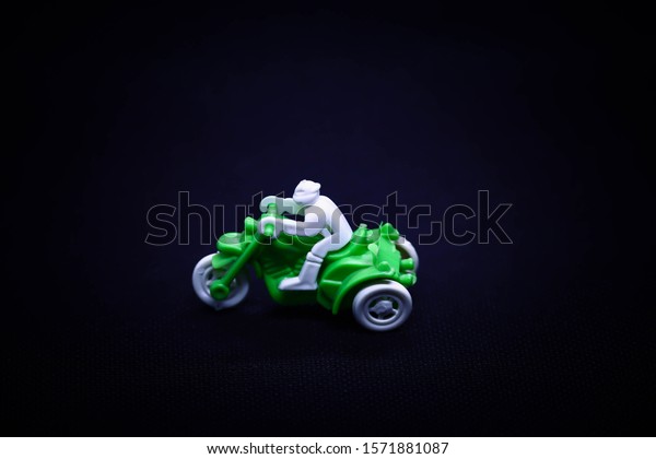 hild toy\
motorcycle Black background Green\
car