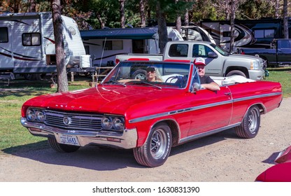 
Hilden, Nova Scotia, Canada - September 21, 2019 : Older Man & Woman Leaving Scotia Pine Show & Shine In A 1964 Buick Skylark Convertible At Scotia Pine Campground.
