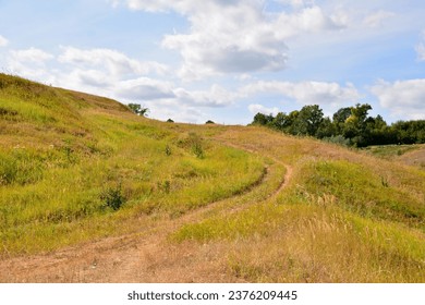 hill with dry grass and road going up copy space   - Powered by Shutterstock