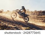 Hill, race and man on dirt bike in desert with adventure, adrenaline and speed in competition, Extreme sport, dust and athlete on off road motorcycle for challenge, power or danger on action course