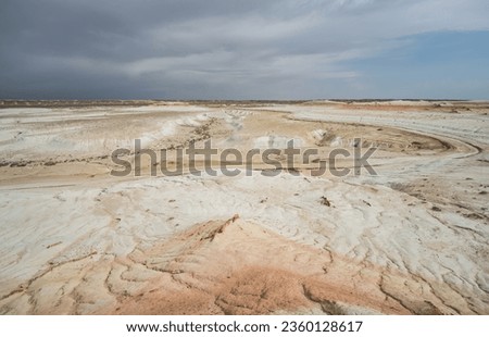Hills of chalk and limestone and slopes of multi-colored mountains with weathering and washouts from water, colored relief in the steppe
