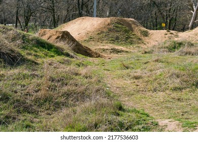 Hills Are On Track For Making Bicycle Tricks. Empty. Shape. Bike. Outdoors. Background. Mountain. No People. Risk. Safety. Transport. Transportation. Stunt. Tire. Biker. Danger. Grass. Day. Road