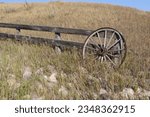 In the hills surrounding Lethbridge Alberta Canada this wagon wheel pays homage to the pioneers who settled in this arid climate. Most of the area is used to grow wheat and other grains now as then.