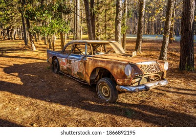 Hillsborough, North Carolina USA-12 03 2020: An Old Orange And Blue Race Car Is Parked Along The Occoneechee Speedway Trail. The Last Race Was In 1968.