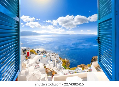 Hillside view through an open window with blue shutters of the caldera, sea and white village of Oia on the island of Santorini, Greece.