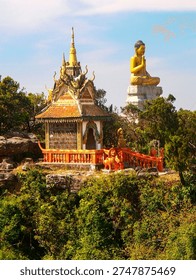 Hilltop Buddhist Temple Complex Overlooking Rural Landscape In Cambodia: Golden Roof Pagodas Surrounded By Forest And Countryside