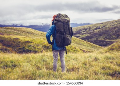 Hillwalker standing in the middle of mountain wilderness