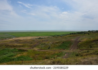 Hilly Terrain With Meadows And A Road