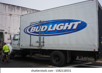 Hilo, Hawaii, USA - Dec 3, 2019: A Truck Driver Unloads A Bud Light Branded Delivery Truck In Downtown Hilo.