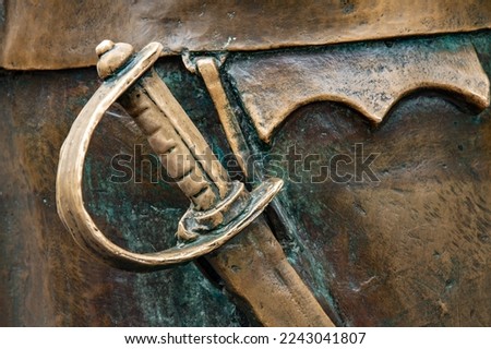 Hilt of sword cast in bronze.