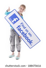 HILVERSUM, NETHERLANDS - APRIL 11, 2014: A Little Girl Isolated On White In Studio, Holding A Like Us On Facebook Sign.