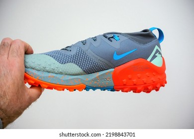 Hilversum, Netherlands - May 5, 2022: POV Male Hand Holding New Nike Wildhorse 7 - Men Trail Running Shoes Isolated On White Background