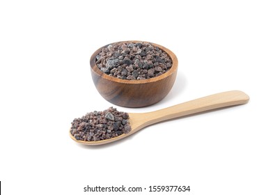 Himalayan black rock salt, Indian Black salt, Hawaiian Black Lava Salt  in a wooden bowl and wooden spoon isolated on white background