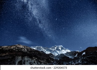 Himalayan Mountain Lhotse Against Dark Blue Sky With Star In Night Time