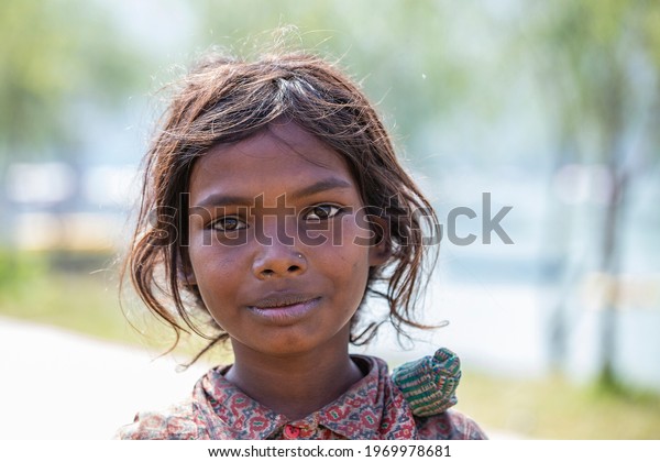 Himalayan mountain\
village, Nepal - oct 23, 2016 : Poor nepalese girl on the street in\
a Himalayan village,\
Nepal
