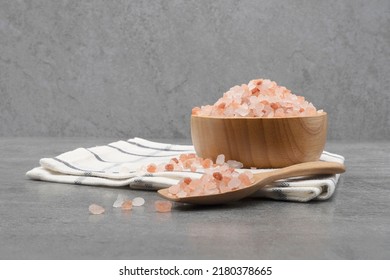 Himalayan pink salt in a wooden cup on a cloth