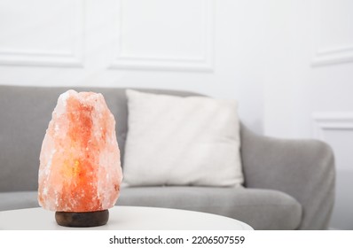 Himalayan Salt Lamp On White Table In Room. Space For Text