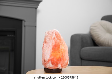 Himalayan Salt Lamp On Wooden Table In Living Room