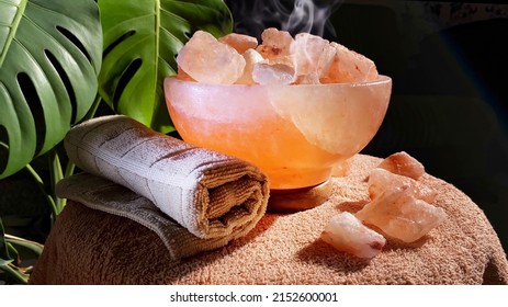 Himalayan Salt Lamps And Towel Rotating On Table In Dark Room. Boost Mood, Improve Sleep, Ease Allergies, Reduce Anxiety And Clean The Air. Copy Space