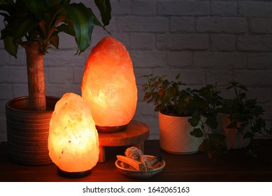 Himalayan Salt Lamps Which Can Boost Mood, Improve Sleep, Ease Allergies,reduce Anxiety And Clean The Air. Warm Orange Colored Light In Dark Room. 