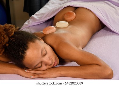 Himalayan Salt Stone Massage On Young Woman At Day Spa