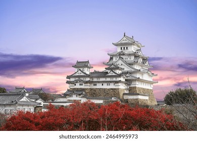 Himeji Castle and red maple leaves in autumn and sunlight in the evening sky in Himeji city Hyogo Prefecture of Japan. - Powered by Shutterstock