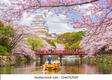Himeji, Japan at Himeji Castle in spring with visitors for the cherry blossom season.