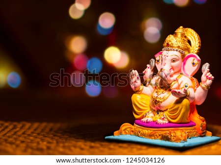 Hindu God Ganesha on blurred bokhe background Ganesha Idol