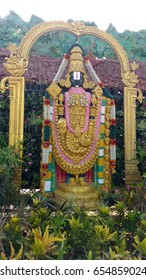 Hindu god lord venkateswara statue with full of greenery