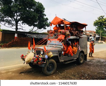 Hindu God Shiva Devotees Travel To Baijnath Temple Deoghar Wearing Orange Dress  On Four Wheeler. Deoghar City Jharkhand State India In The Month Of Shravan Of Indian Calendar. Clicked On 31 July 2018